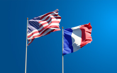 Beautiful national state flags of France and USA together at the sky background. 3D artwork concept.