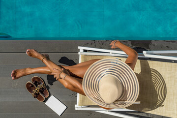 Fototapeta premium woman at spa resort by the swimming pool.