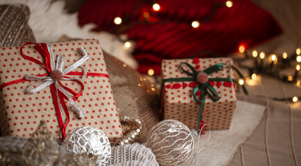 Christmas gifts in beautiful wrapping paper close up on a blurred background. Christmas atmosphere and holiday concept.