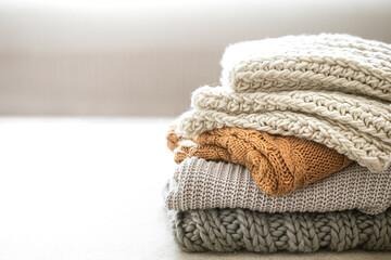 Fototapeta na wymiar A stack of neatly folded warm knitwear, wool close up.