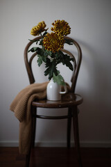 Autumn concept composition: hat, sweater, dry leaves and mini pumpkins