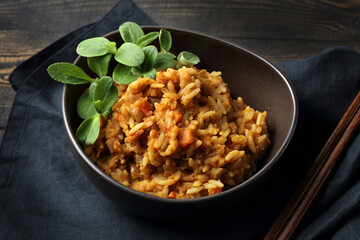 Spicy mujadra with rice, orange lentils, carrots, onions and borago sprouts