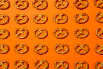 Flat lay with cracker pretzels on orange background
