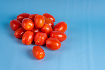 Group of Cherry Tomatoes isolated on blue background