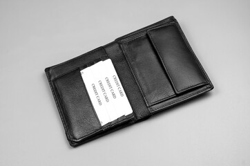 Leather black wallet for money on a gray background