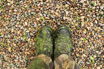 lawnmower's boots covered with finely cut grass