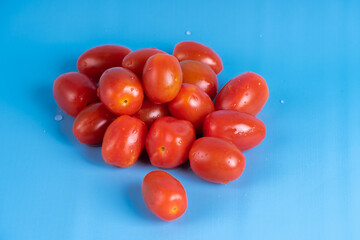 Group of Cherry Tomatoes isolated on blue background