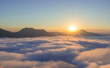 Fototapeta na wymiar beautiful sunrise over mountain with fog in the morning