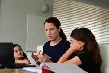 Mother homeschooling her two young