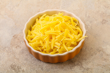 Shredded yellow cheese in the bowl