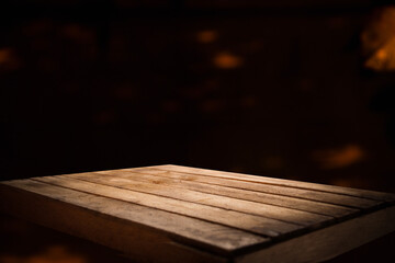 vintage wooden table with blurred bokeh background space, cosmos. Place for products