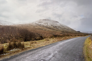 Mountain peak covered with snow at winter season in Gleniff Horseshoe Drive, county Sligo, Ireland. Popular tourist route