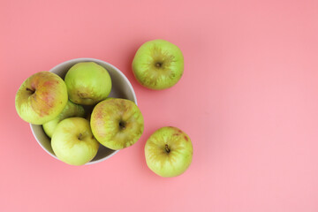 sweet green apples in a pink plate