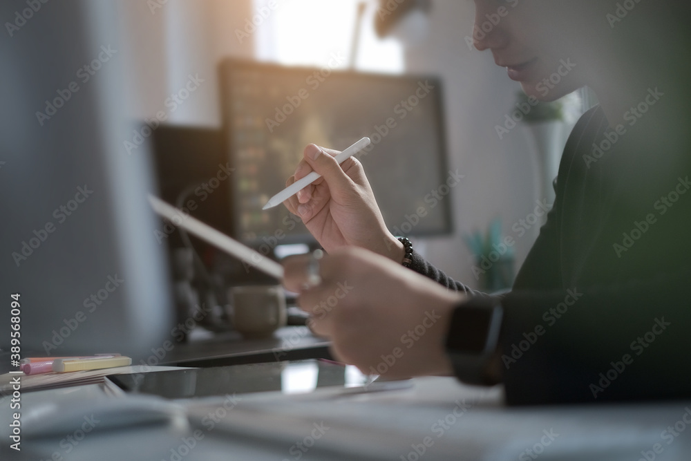 Poster cropped shot of illustrator graphic designer working with digital tablet and computer at his workspa
