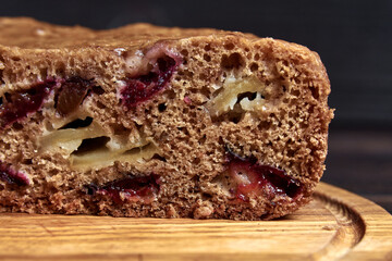 Chocolate charlotte pie on a wooden tray in a cut, close-up