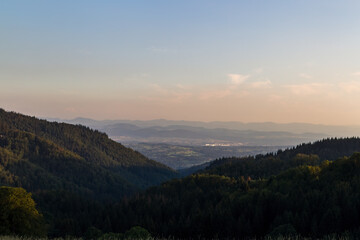 Fototapeta premium Panorama at sunset from the mountains of the Black Forest near Gersbach over the Wehratal and the city of Wehr towards the Swiss Alps