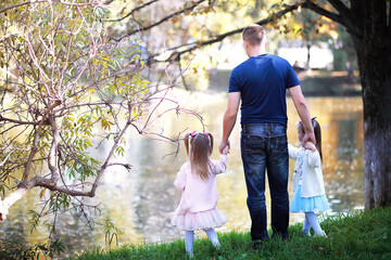 Fototapeta premium Leaf fall in the park. Children for a walk in the autumn park. Family. Fall. Happiness.