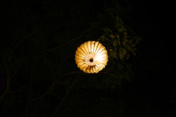 Traditional lighting umbrella shape from small lamps at night. Festival concept with Copy space.