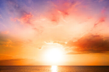 World Environment Day concept: Colorful ocean beach sunrise with deep Orange sky and sun rays