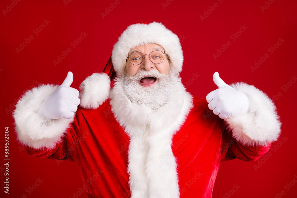 Wall mural Portrait of crazy funky santa claus show ok sign x-mas tradition fairy sales wear red costume white gloves isolated over bright shine color background