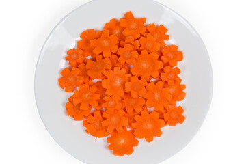 Top view of figured chopped carrots on white dish, fragment
