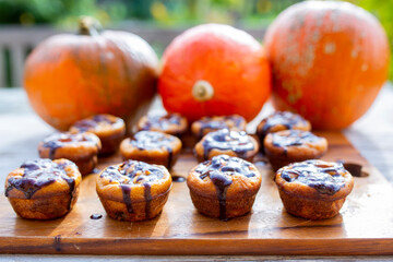 Homemade pumpkin muffins on a table in the garden.