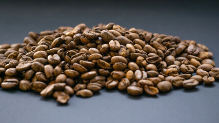 Fototapeta premium Coffee is filled with a slide on a dark, flat surface. Morning sip of energy in a dark drink.