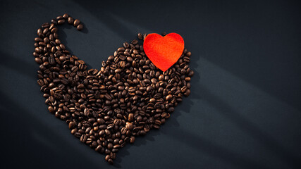 Coffee is filled with a slide on a dark, flat surface. Morning sip of energy in a dark drink.