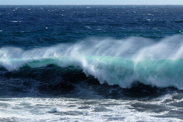 Fototapeta premium Big waves on indian ocean at the shore of Reunion island just moments before hitting the water on a very windy and sunny day.