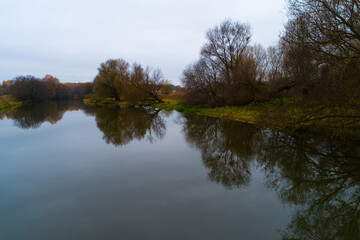 Fototapeta na wymiar Autumn landscape with a river and trees.