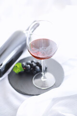 Glass with grape red semi-dry wine. Valentine's day concept background. Gift for the holiday. Sweet sparkling wine.