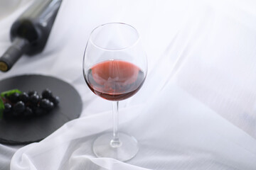Glass with grape red semi-dry wine. Valentine's day concept background. Gift for the holiday. Sweet...