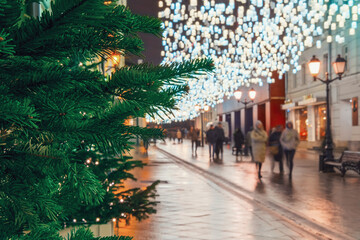 Obraz premium Evening city street with hurrying people, new year's eve and christmas