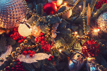 Christmas tree decorated with glass beads, mistletoe branch and baubles. Preparing to celebrate the...