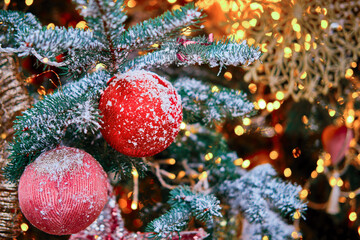 Obraz na płótnie Canvas Soft homemade balls sewn as decoration for New Years celebration, close-up. Winter christmas tree with bauble, copy space