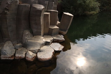 Large hexagonal stones at water side at Golan heights
