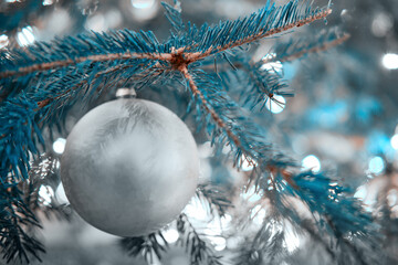 White silver ball as decoration for New Years celebration, close-up. Winter christmas tree with bauble, copy space