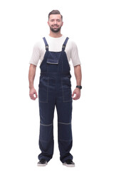 confident young man in blue overalls . isolated on white