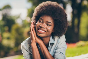 Close-up photo portrait of black skinned young female student smiling carelessly keeping hands near...
