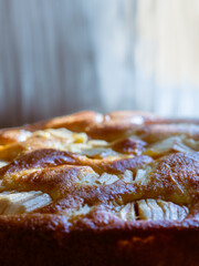 delicious traditional home made apple cake on with a blurred background with focus on a part of the cake 