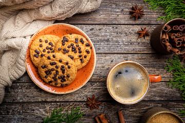 Homemade Chocolate chip cookies with coffee on rustic wooden table, top view