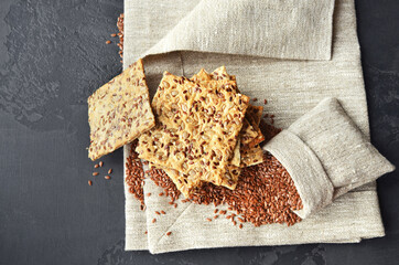 Multigrain crispbread with flax seeds in a burlap bag.