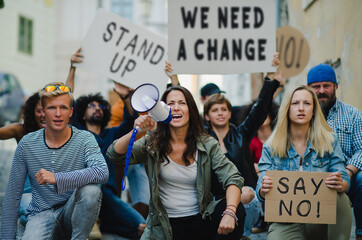 Group of people activists protesting on streets, strike, demonstration and coronavirus concept.