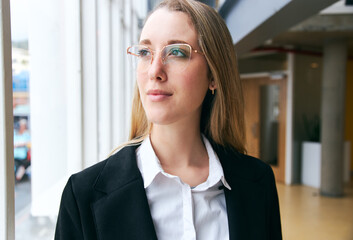 Portrait Of Young Businesswoman Wearing Glasses Standing In Modern Office During Health Pandemic