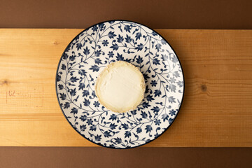 goat cheese on brown background