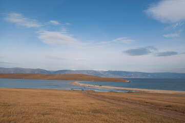 Baikal lake fresh water
flora shore reserve Russia Irkutsk park island Sky clouds clear Olkhon rocks trees embankments sand bay lagoon stones mountains hills horizon line panorama autumn water waves 
