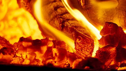 Close up shot of burning firewood in the fireplace. low light