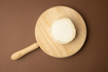 goat cheese on brown background