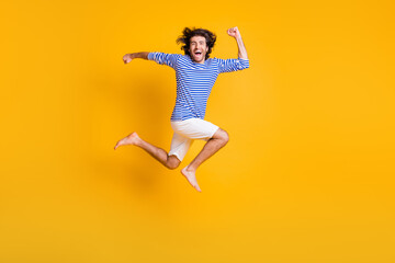 Full body profile side photo of excited guy jump up run fast wear nautical vest isolated over bright shine color background