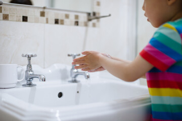 young girl washing hand by herself at bathroom